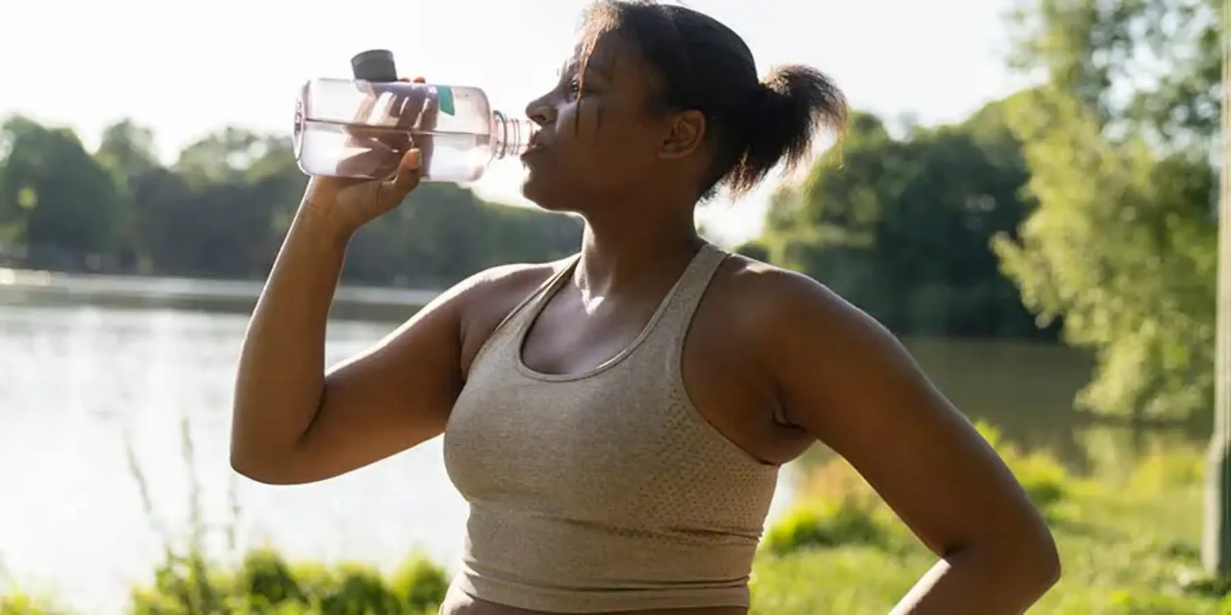 Young African American woman drinking water