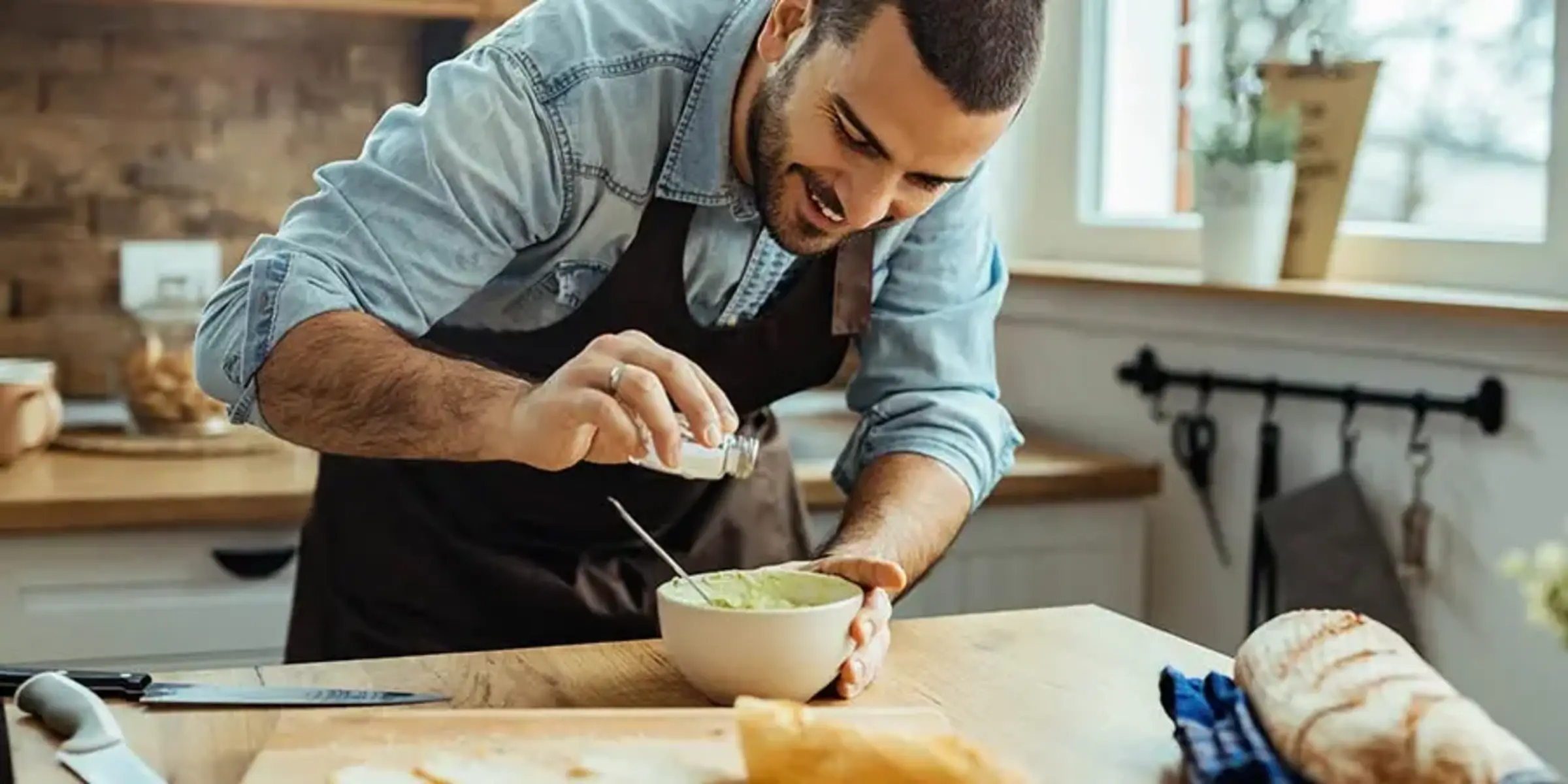 man adding salt to a dish