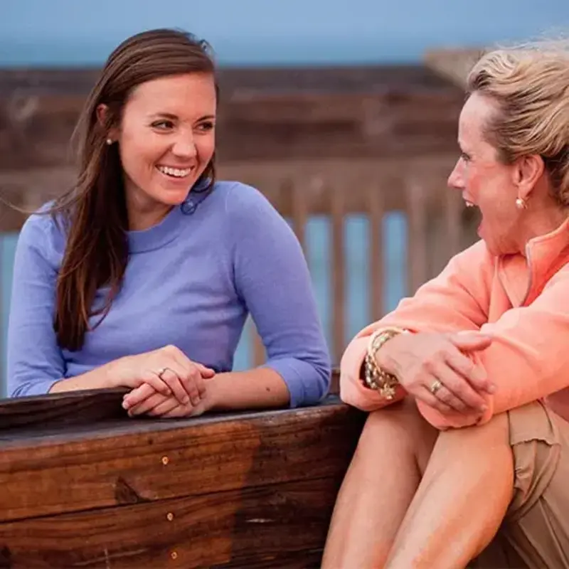 friends laugh on boardwalk