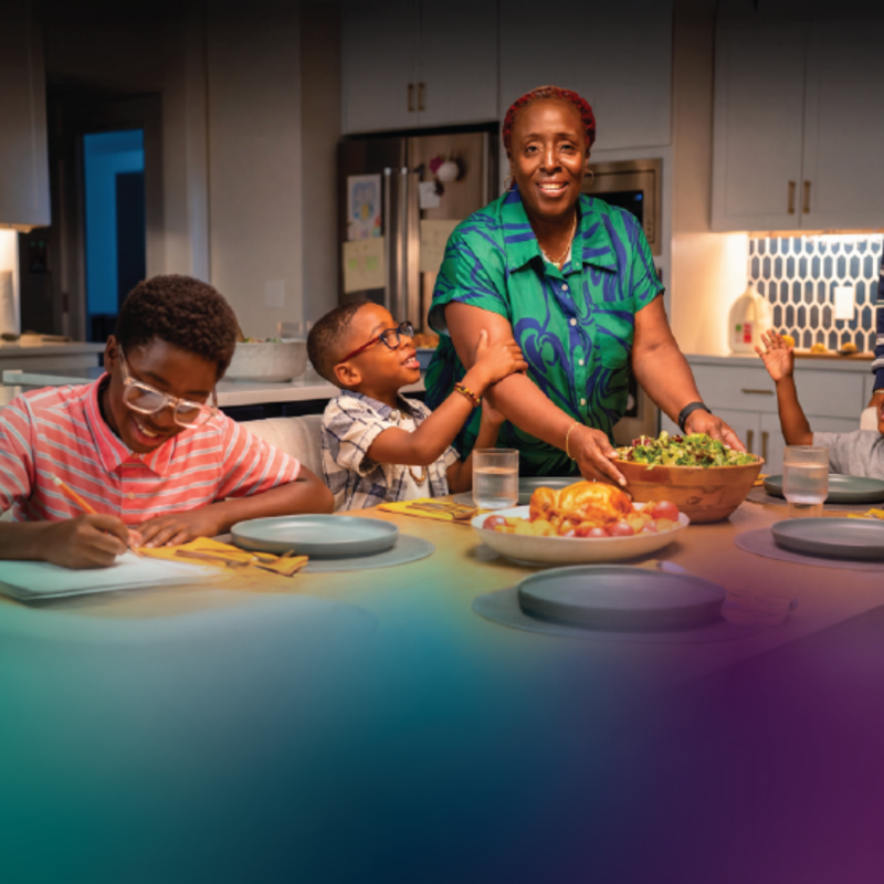 Family gathered around a dinner table sharing a meal