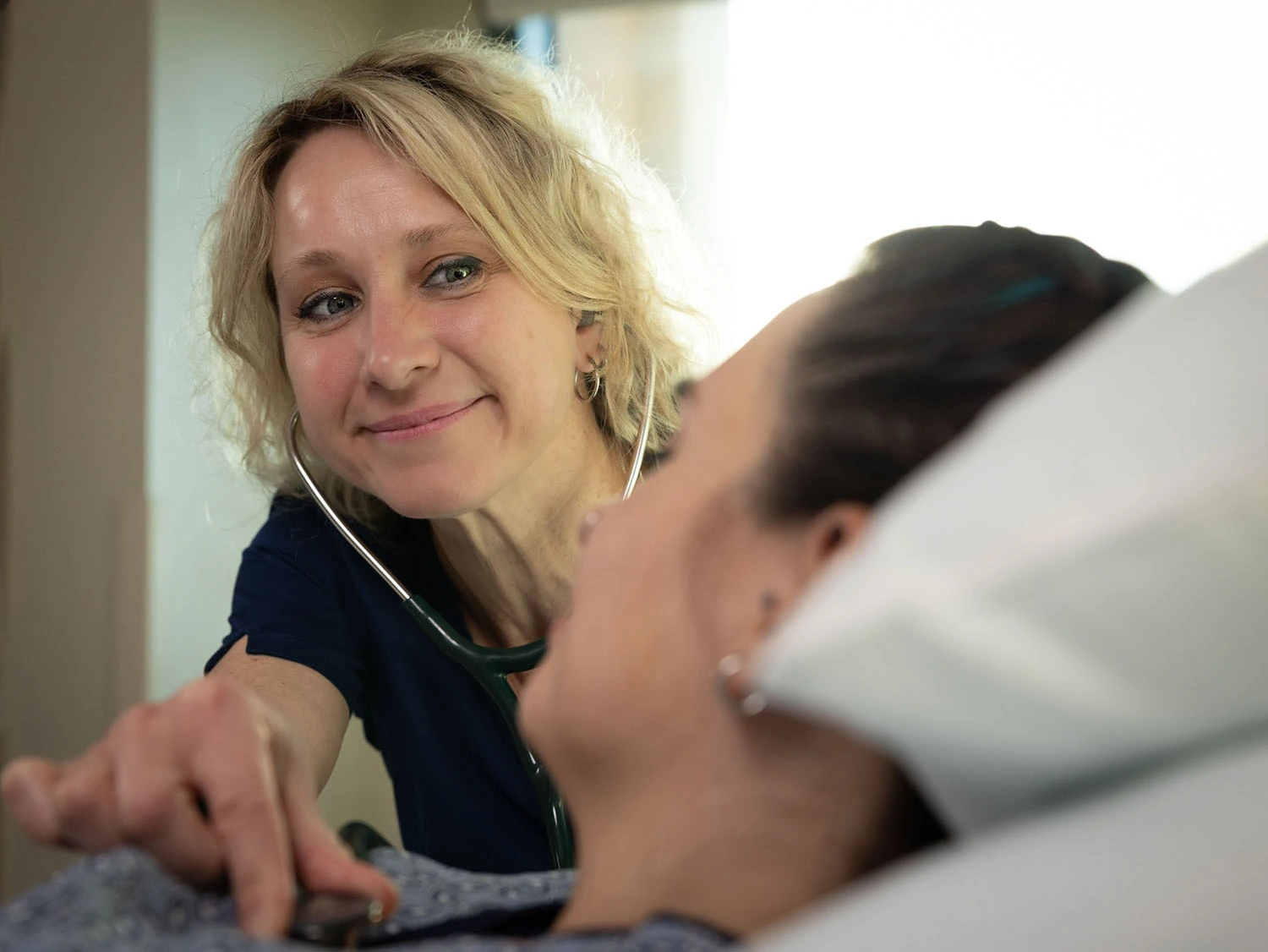 experienced nurse checking patient vitals experienced nurse checking patient vitals