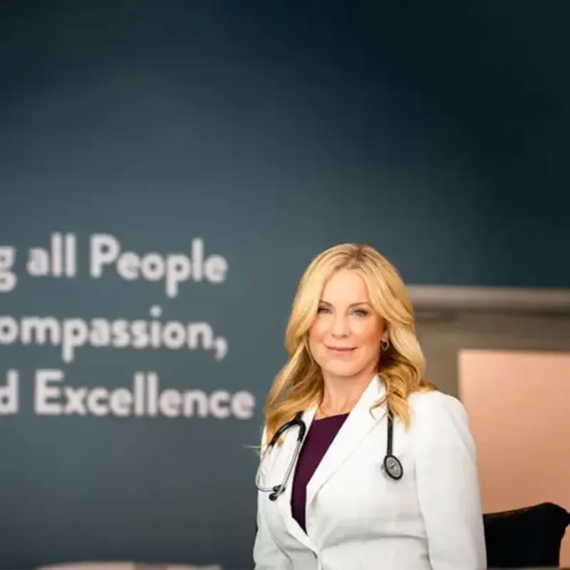 doctor McPherson in front of Roper motto