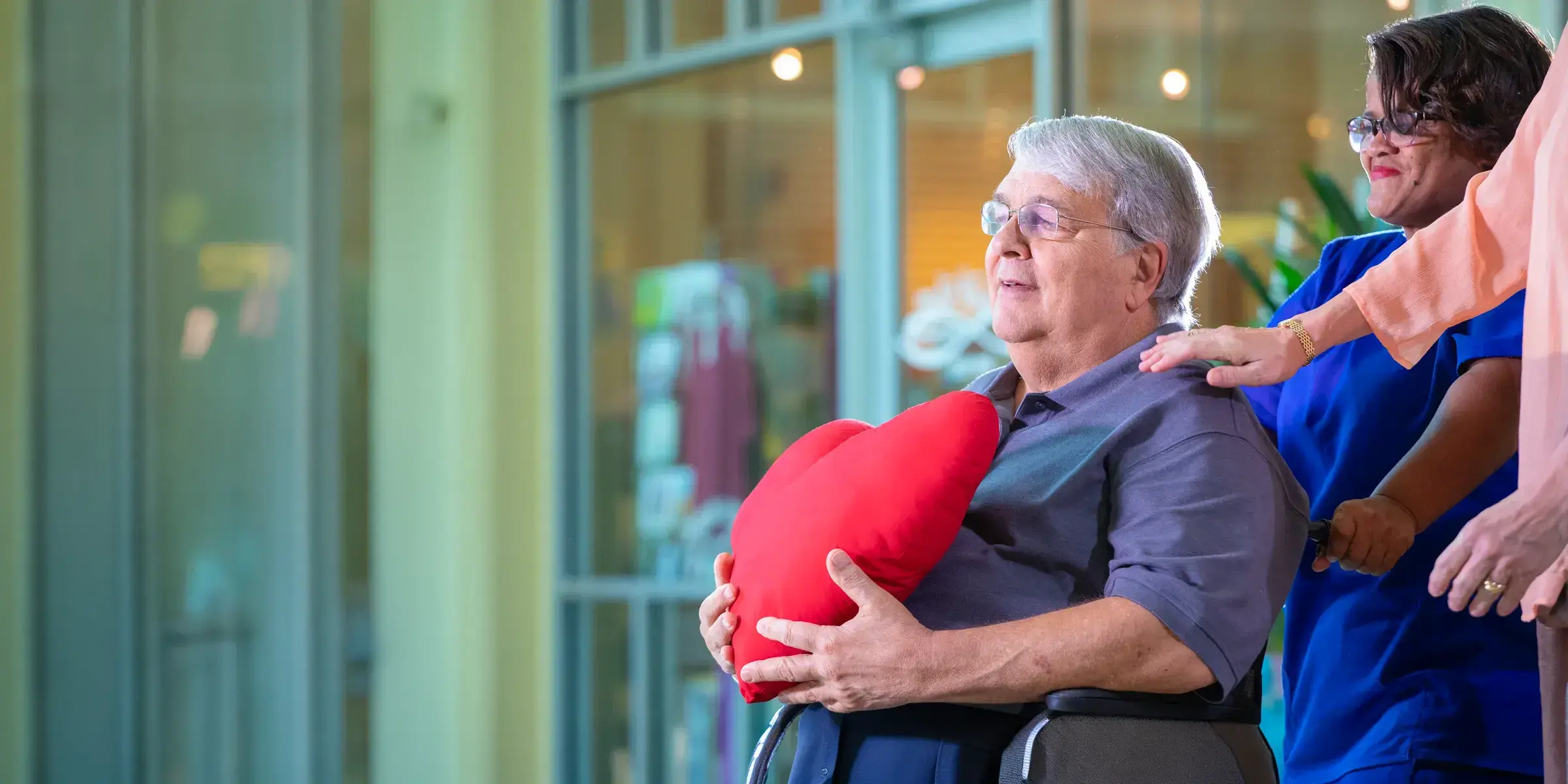 Man holds heart shaped pillow