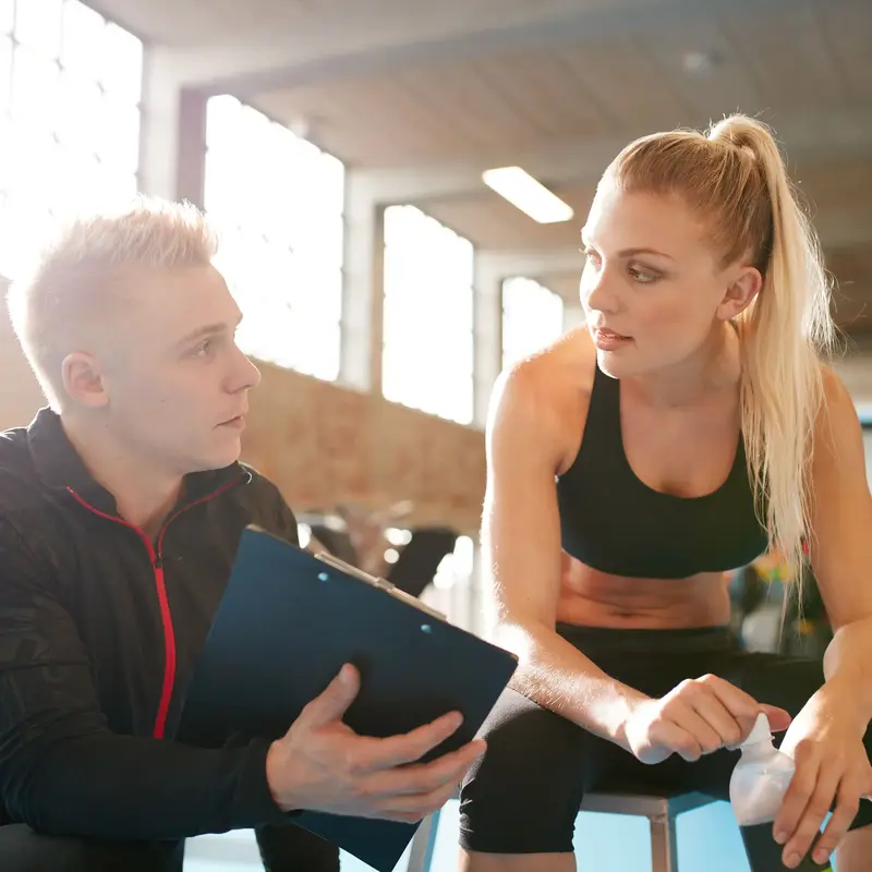student athlete talking with physical therapist