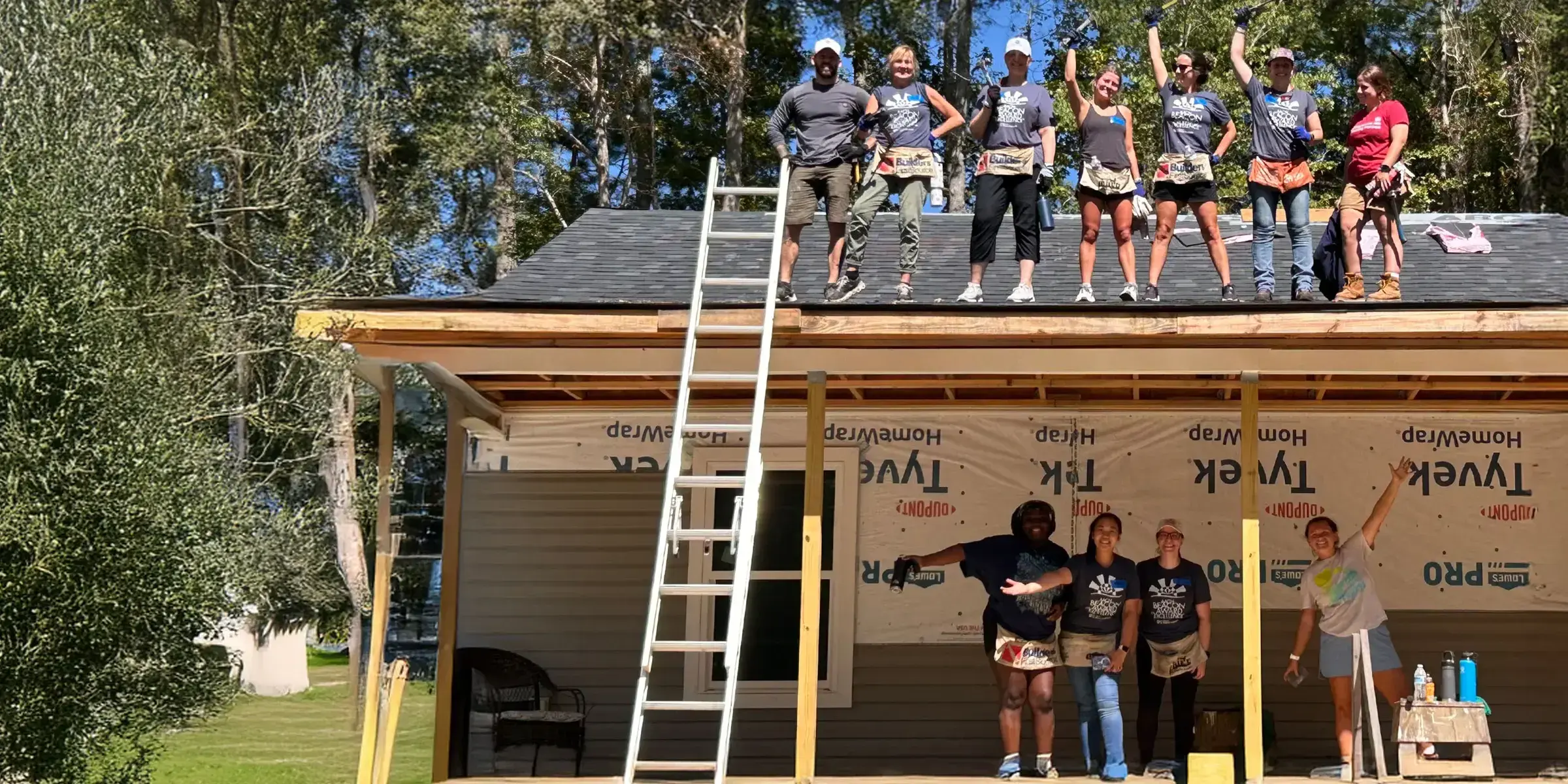Group of people on roof building house