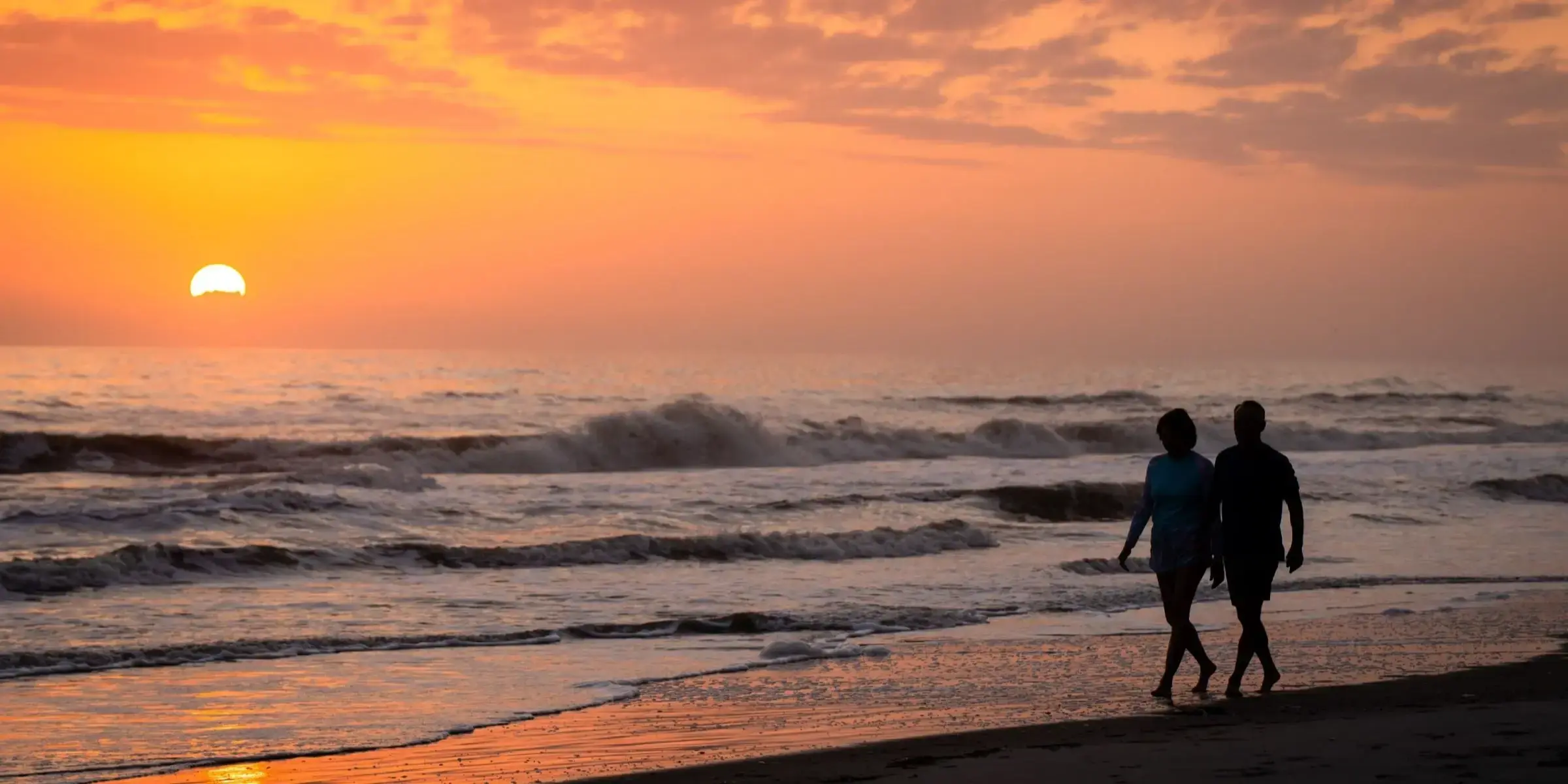 Sunrise beach walk couple