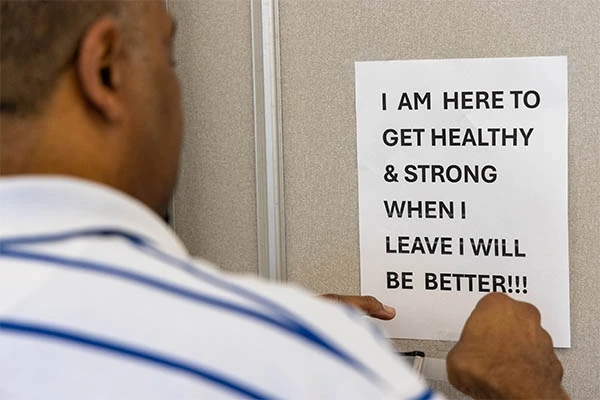Ron White posting a sign in the classroom