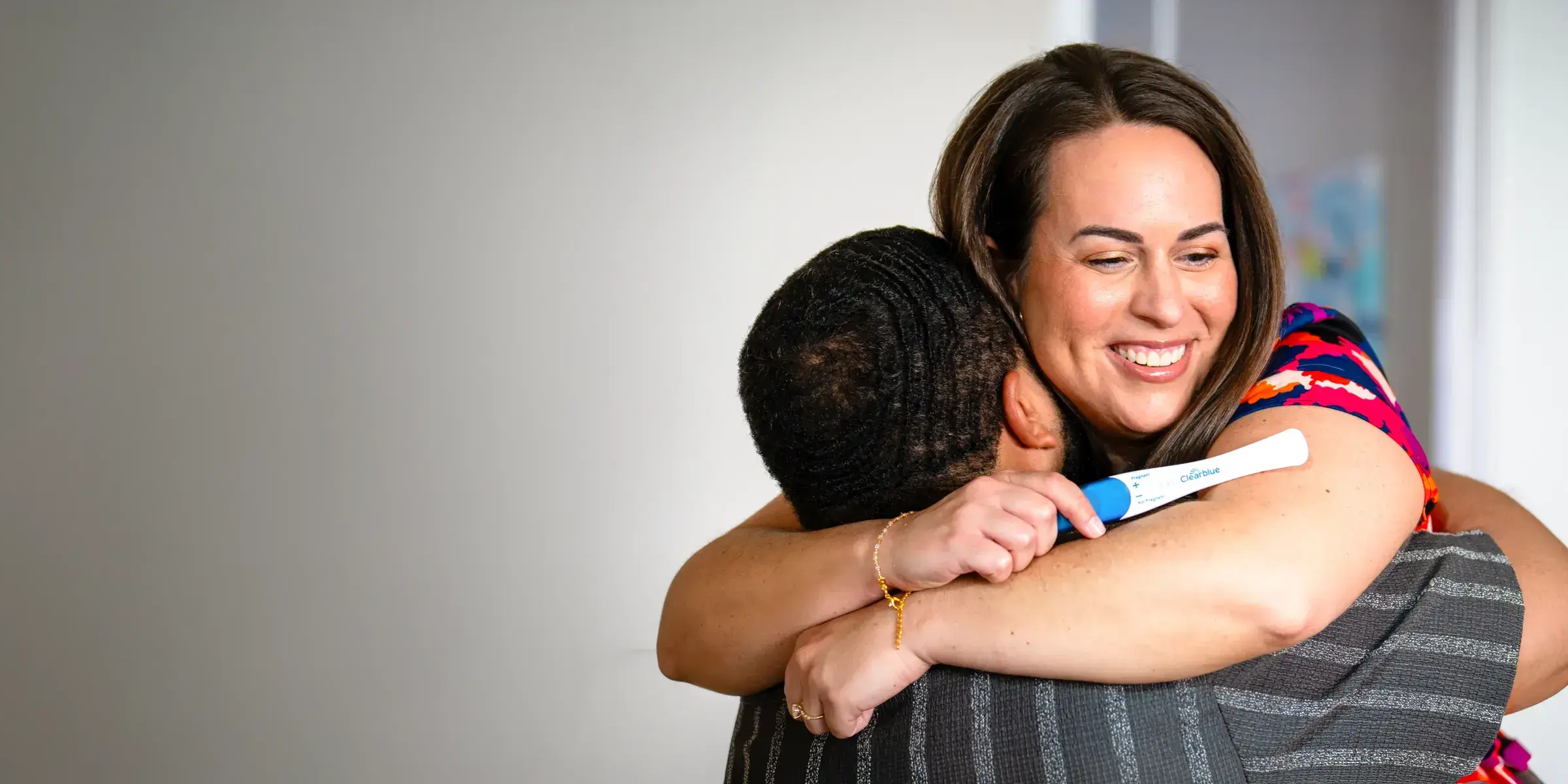 Pregnancy test couple hug