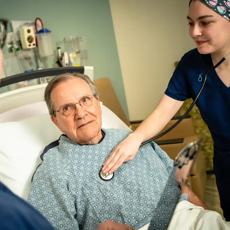 Nurse listens to patient heart