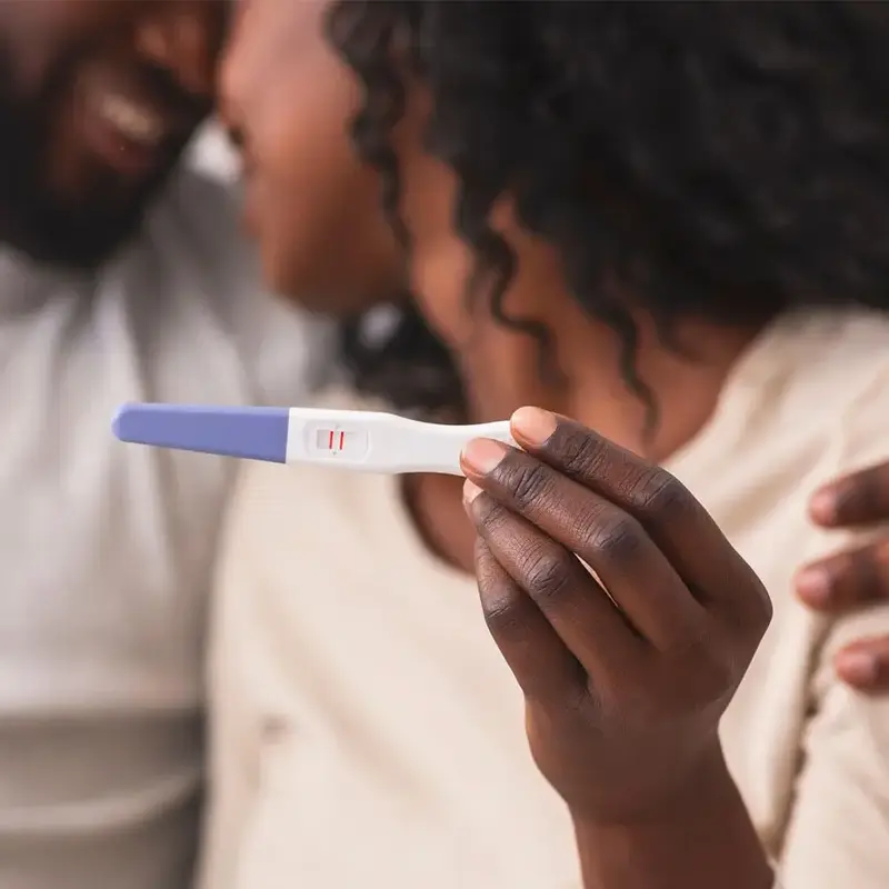 couple holding a pregnancy test