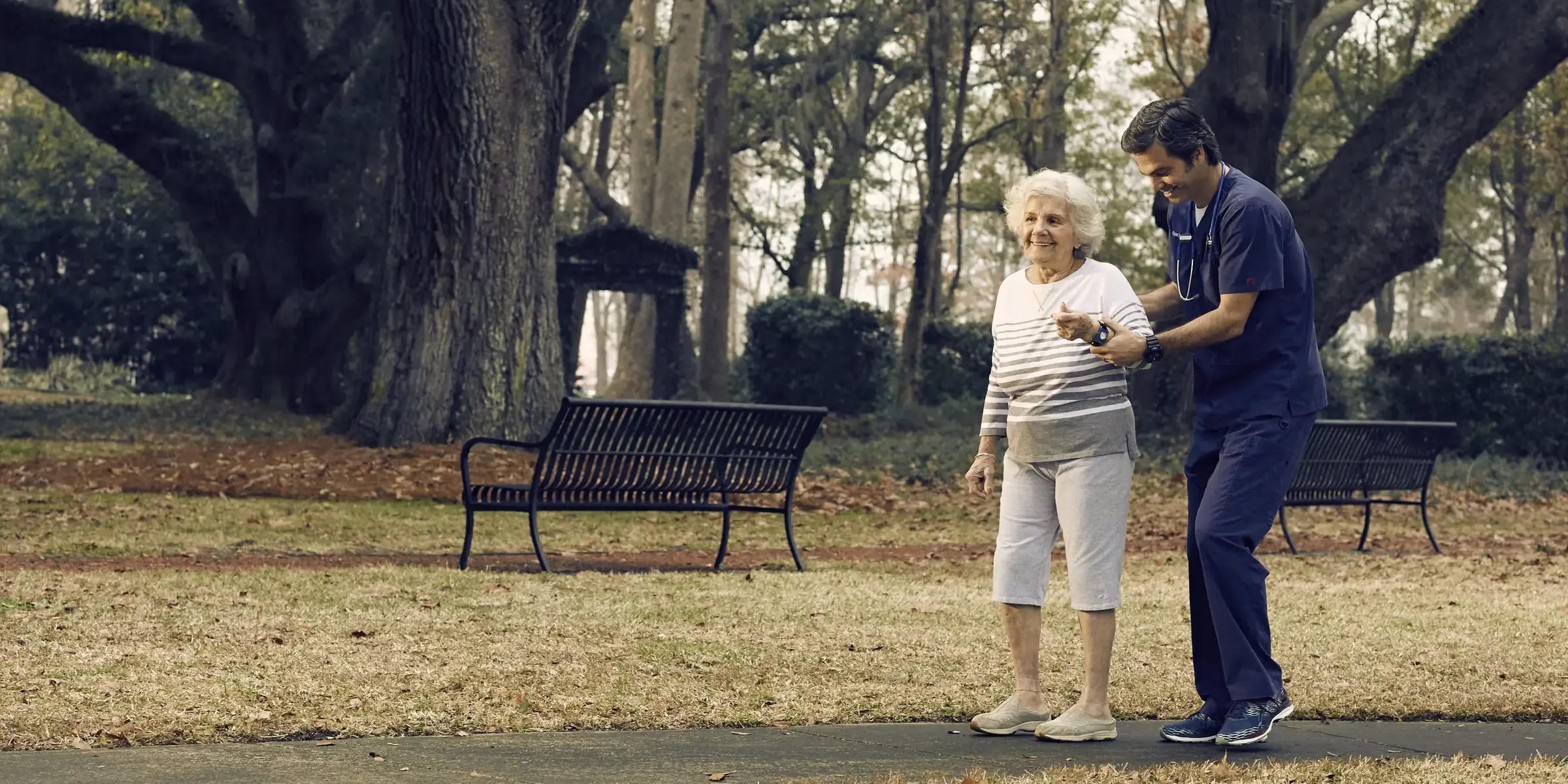 male nurse and patient walking outside