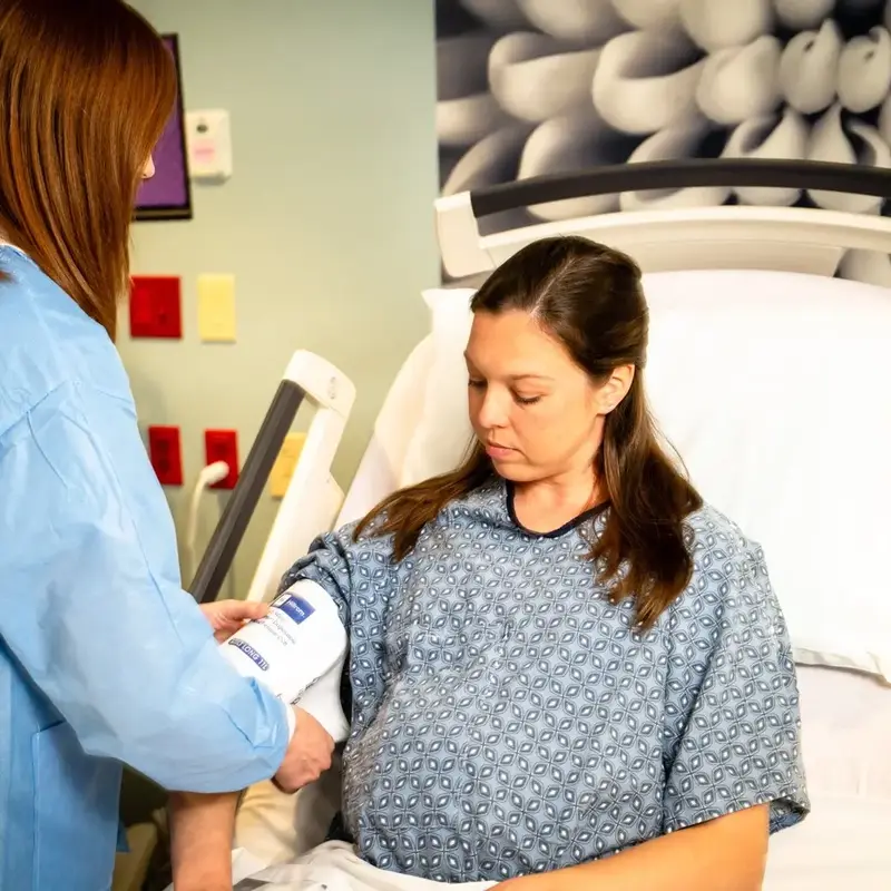 Nurse takes pregnant patient blood pressure