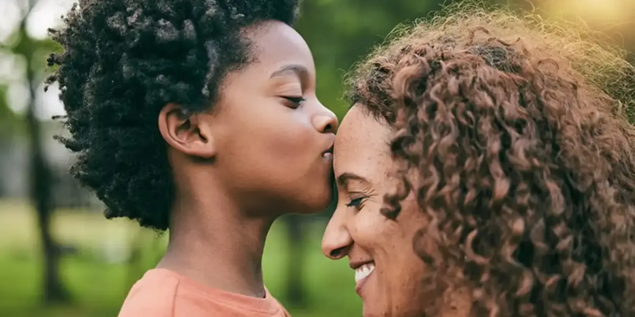 Son kissing a mother on the forehead