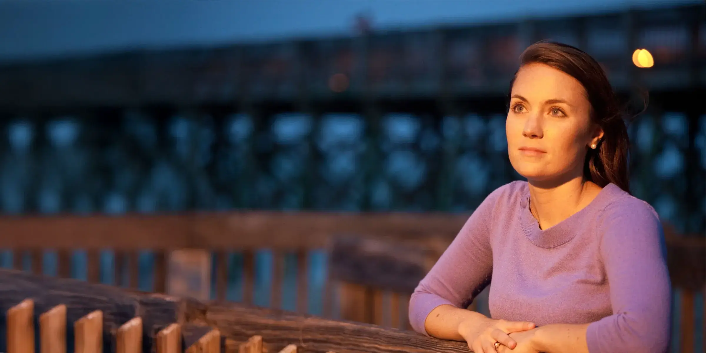 Woman stands on pier