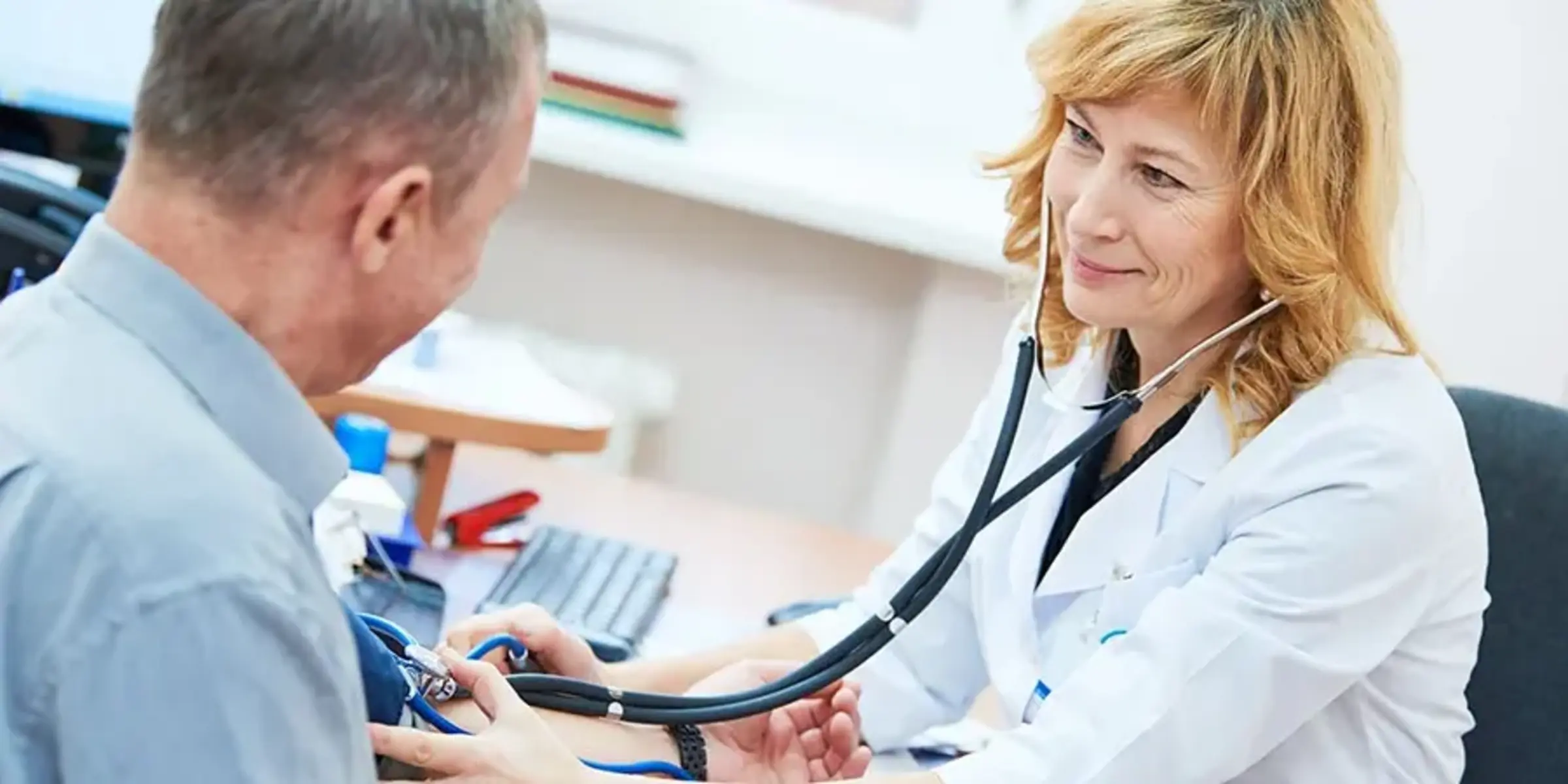 physician doctor is checking the blood pressure of the patient