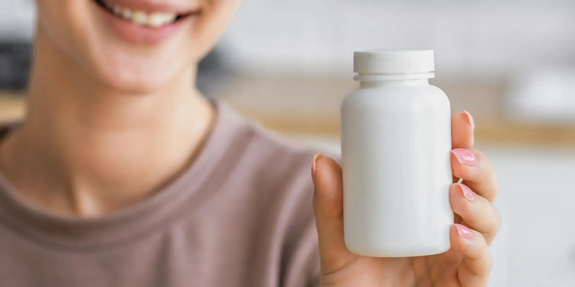 woman holds pill bottle