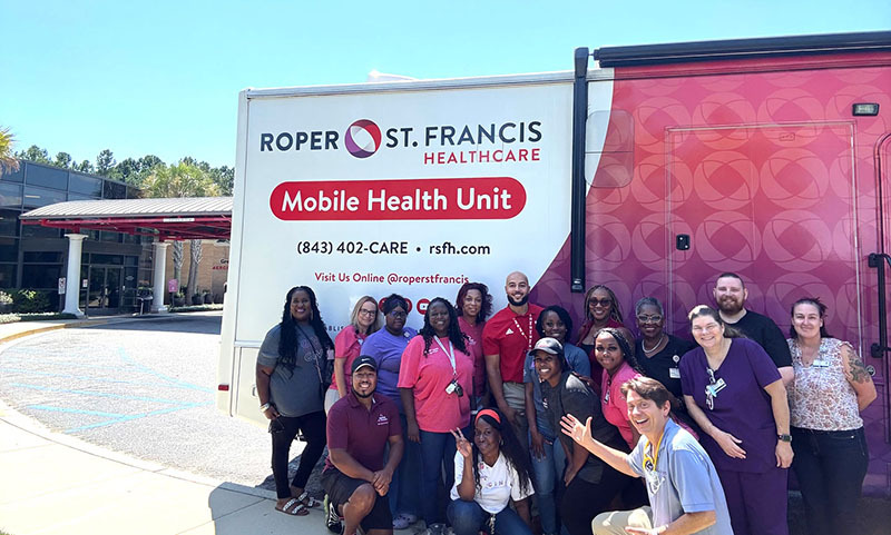 mobile health unit team in front of vehicle