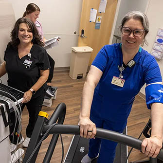 two nurses moving equipment at Berkeley Hospital Heart and Vascular center