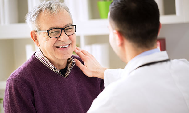 older male patient talking to male doctor