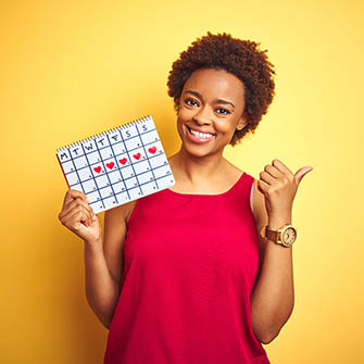 African American women holding a calendar