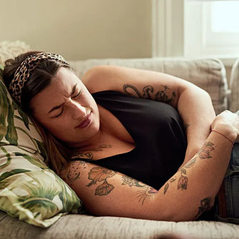 woman holding stomach period pain