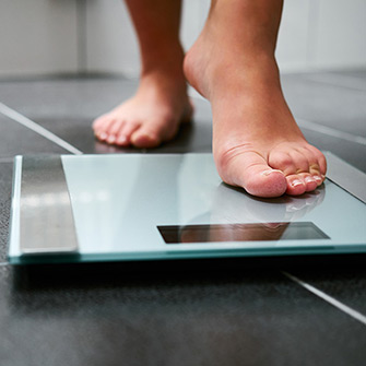 woman stepping on scale