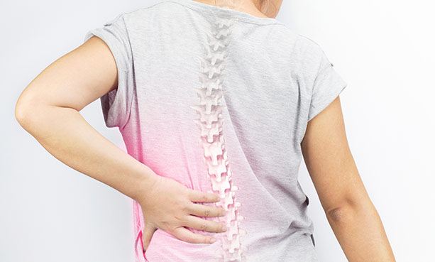 woman hold holding back and spinal xray