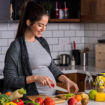 pregnant woman prepping meal