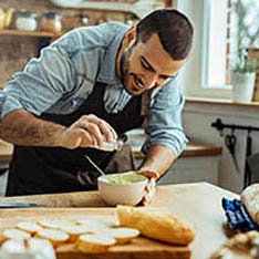 man adding salt to food